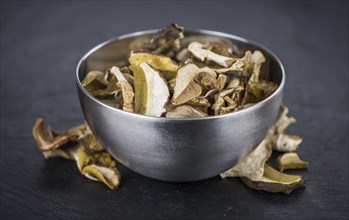 Dried Porcinis on a vintage slate slab as detailed close-up shot, selective focus