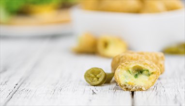 Portion of homemade Chili Cheese Nuggets on wooden background (selective focus, close-up shot)