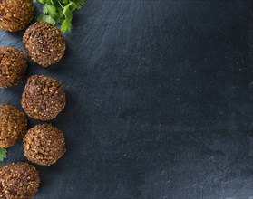 Homemade Falafel (close-up shot, selective focus) on wooden background