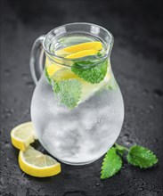 Homemade Lemonade on vintage background (selective focus, close-up shot)