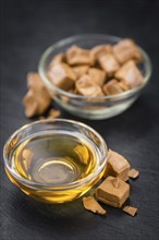 Caramel Sirup on a vintage background as detailed close-up shot (selective focus)