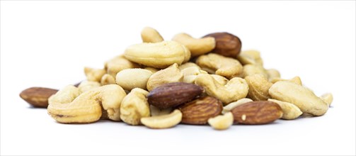 Fresh roasted nuts isolated on white background as close up shot (selective focus)