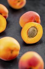 Portion of Apricots as detailed close up shot on a slate slab (selective focus)