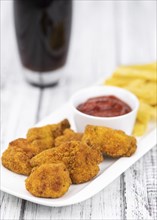 Homemade Chicken Nuggets on vintage background (selective focus, close-up shot)