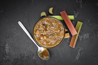 Homemade Rhubarb Jam on rustic background (close up shot, selective focus)