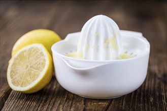 Fresh made Juice (lemon) on an old and rustic wooden table (selective focus, close-up shot)