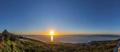 Tourists watching the sunset from Signal Hill, Cape Town South Africa during winter season