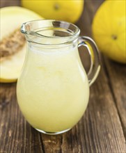 Homemade Honeydew Melon Smoothie on wooden background (selective focus)