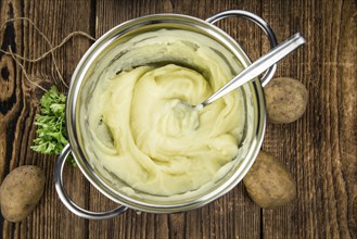 Potato Mash on rustic wooden background (close-up shot)