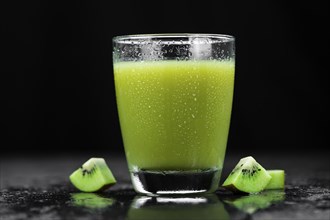 Kiwi Smoothie (selective focus) on an old and vintage background (homemade)