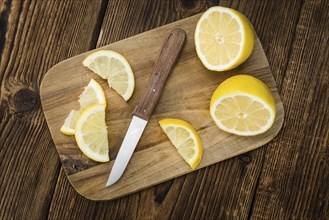 Homemade Lemon Slices on an wooden table (selective focus) as detailed close-up shot