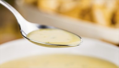 Chanterelle Soup as high detailed close-up shot on a vintage wooden table, selective focus