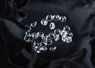 Small Diamonds on dark background as close up shot (selective focus)