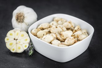 Fresh made Garlic (preserved) on a vintage background (close-up shot)