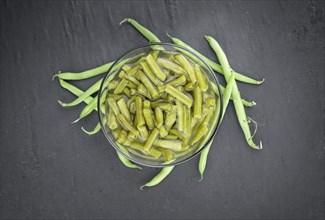 Preserved Green Beans as detailed close-up shot (selective focus) on vintage background