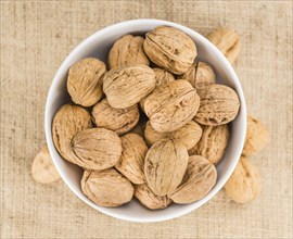 Walnuts on a vintage background as detailed close-up shot (selective focus)