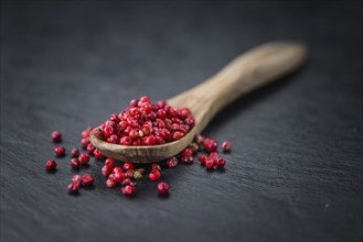 Pink Peppercorns on a vintage background as detailed close-up shot, selective focus