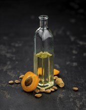 Portion of Apricot Oil with some fresh fruits as detailed close up shot (selective focus)