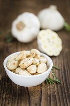 Portion of fresh Preserved Garlic (close-up shot, selective focus)