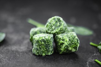 Frozen spinach cubes as detailed close up shot (selective focus)