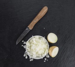 Diced white onions on a vintage background as detailed close-up shot, selective focus