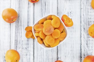 Dried Food (Apricots) on an old wooden table as detailed close-up shot (selective focus)
