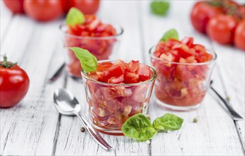 Homemade Cutted Tomatoes on vintage background (selective focus, close-up shot)