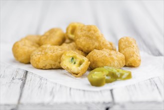 Chili Cheese Nuggets on a vintage background as detailed close-up shot (selective focus)