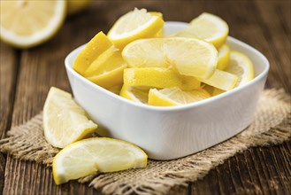 Fresh made Lemon (sliced) on a vintage background (close-up shot)