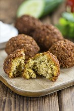 Portion of Falafel on an old wooden table (close-up shot, selective focus)