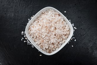 Portion of Himalayan Salt on a rustic slate slab (selective focus, close-up shot)