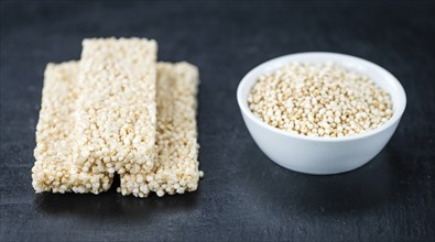 Slate slab with fresh made Quinoa Bars (close-up shot, selective focus)