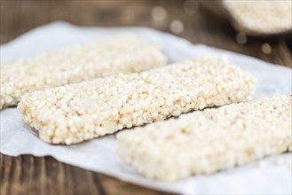 Quinoa Bars on a wooden table as detailed close-up shot (selective focus)