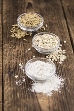 Some Oat Flour on a vintage wooden table (selective focus, close-up shot)