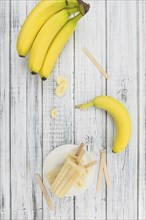 Banana Popsicles on vintage background as detailed close-up shot (selective focus)