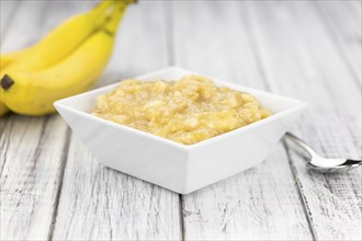 Banana Mash (close-up shot) on a vintage wooden table (selective focus)