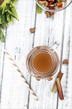 Rhubarb Juice on a rustic background (close up shot, selective focus)