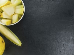 Fresh made Yellow Honeydew Melon on a vintage background (close-up shot)