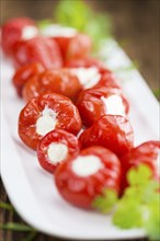 Homemade Filled Pimientos on vintage background (selective focus, close-up shot)