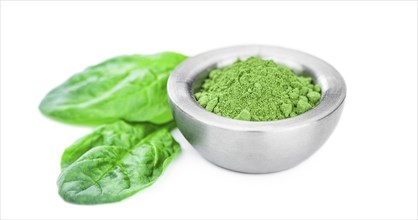 Spinach powder isolated on white background (close up, selective focus)