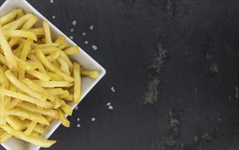 Portion of fresh made crispy French Fries (selective focus, close-up shot)