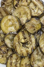 Fresh made Zucchinis (grilled) on an old and rustic wooden table (selective focus, close-up shot)