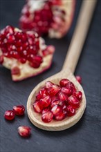 Pomegranate on a vintage background as detailed close-up shot (selective focus)