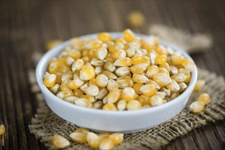 Wooden table with a portion of Corn (selective focus, close-up shot)