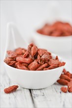 Goji Berries on a vintage background as detailed close-up shot (selective focus)