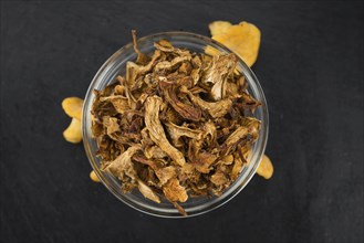 Portion of Dried Chanterelles on a rustic slate slab, selective focus, close-up shot