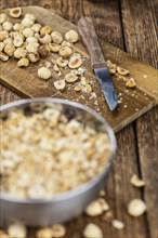 Freshly chopped Hazelnuts as detailed close up shot (selective focus)