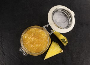 Portion of Pineapple Jam on a rustic slate slab, selective focus, close-up shot