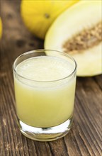 Homemade Honeydew Melon Smoothie on wooden background (selective focus)