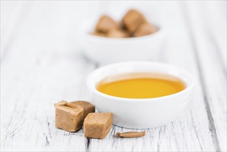 Portion of fresh Caramel Sirup (close-up shot, selective focus)